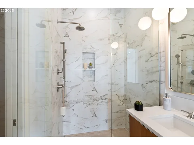 a living room with furniture a large window and dresser