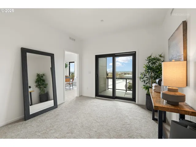 a bedroom with a bed and a large window