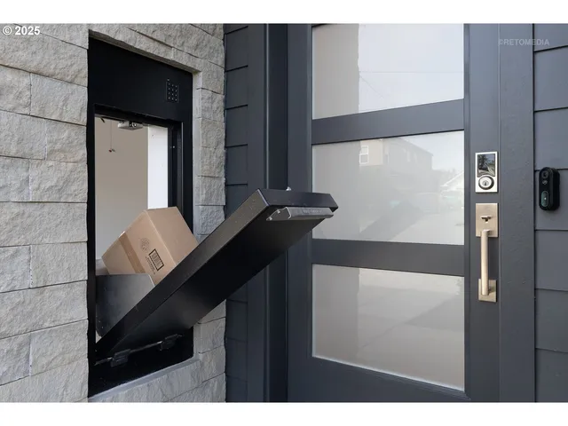 a kitchen with stainless steel appliances granite countertop a sink a stove a refrigerator cabinets and chairs