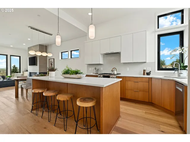 a kitchen with kitchen island a sink stainless steel appliances and cabinets