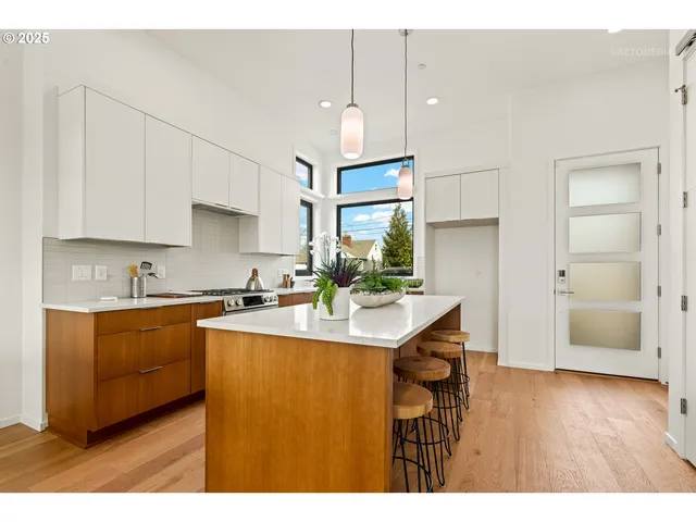 a kitchen with a stove a sink a counter space and a window