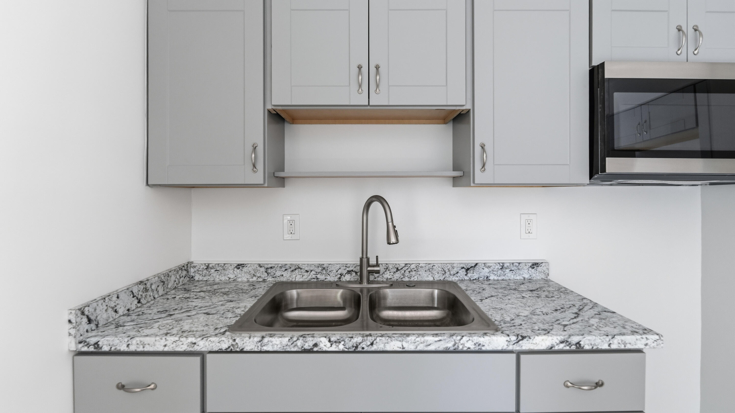 4453 Stevens Road Lake Worth Beach, FL 33461 - Photo 54 of 67 a kitchen with granite countertop a sink a stove and cabinets