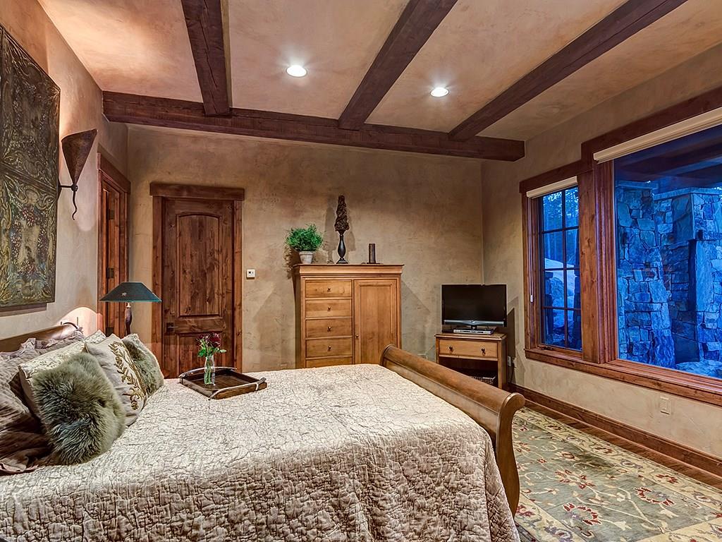 462 Peerless Drive Breckenridge, CO 80424 - Photo 23 of 25 a bedroom with a bed and a flat screen tv