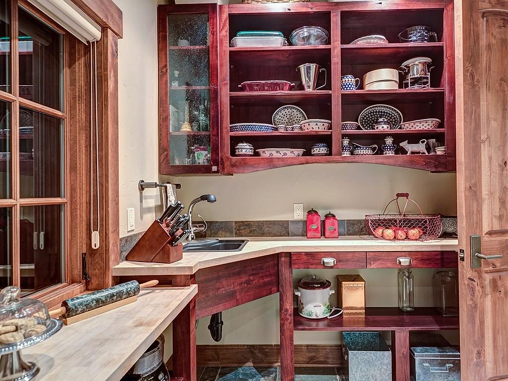 462 Peerless Drive Breckenridge, CO 80424 - Photo 10 of 25 a kitchen with a wooden floor and cabinets