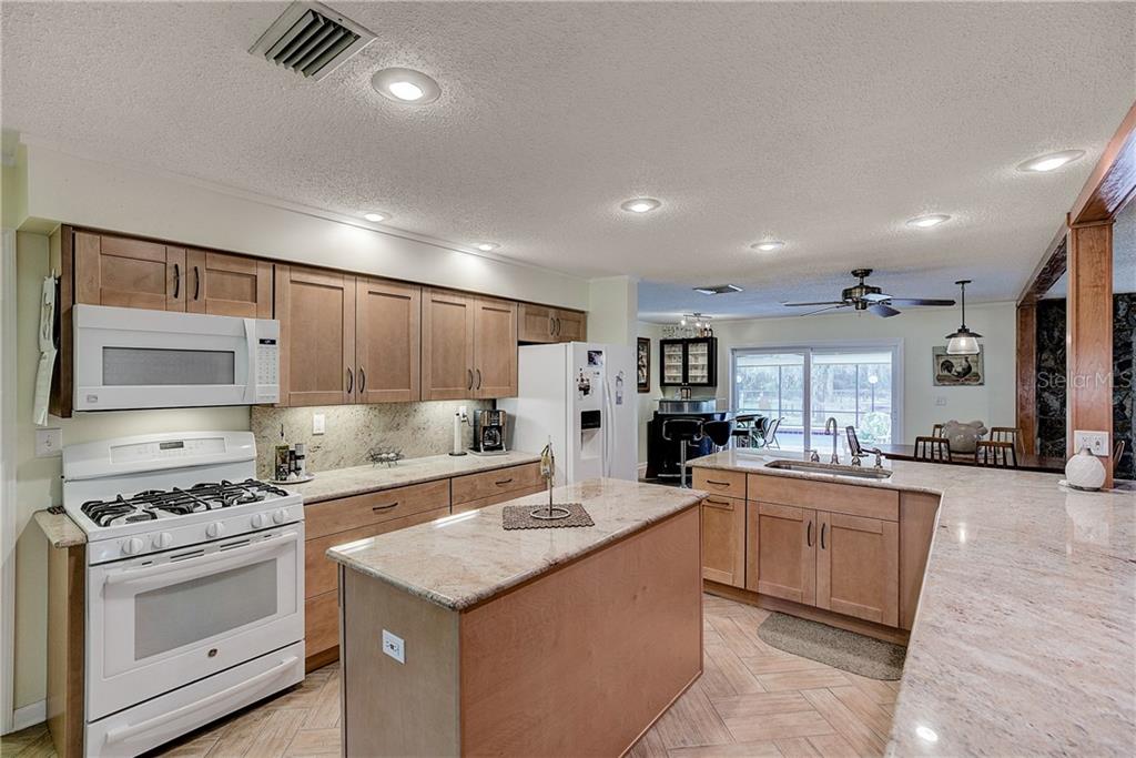 4873 Old Ranch Road Sarasota, FL 34241 - Photo 13 of 49 The kitchen has a lot of counter space, and solid wooden cabinets.