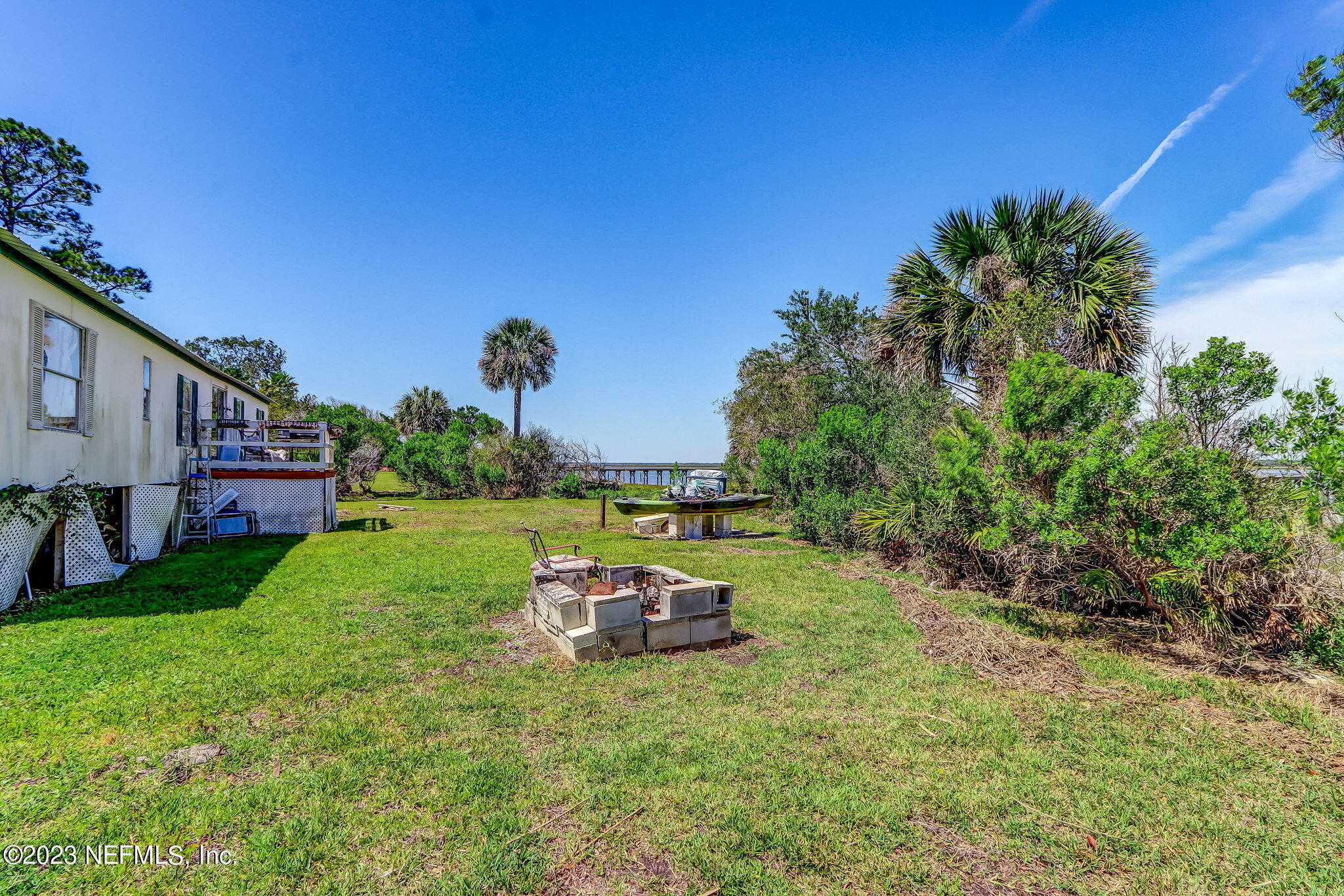16225 Shellcracker Road Jacksonville, FL 32226 - Photo 10 of 18 a backyard of a house with table and chairs plants and a large tree