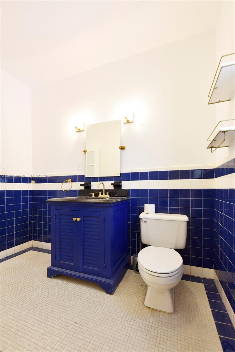 7613 Biscayne Boulevard, Unit 1 Miami, FL 33138 - Photo 11 of 16 a bathroom with a toilet sink and mirror