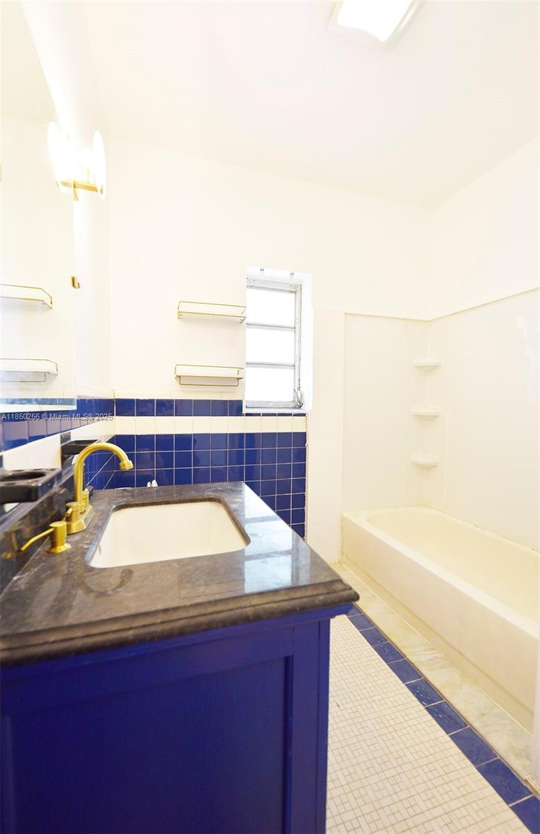 7613 Biscayne Boulevard, Unit 1 Miami, FL 33138 - Photo 12 of 16 a bathroom with a sink and a bathtub
