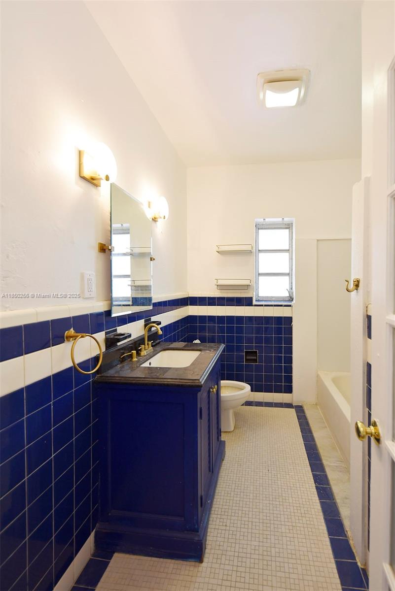 7613 Biscayne Boulevard, Unit 1 Miami, FL 33138 - Photo 13 of 16 a kitchen with a sink and a stove top oven