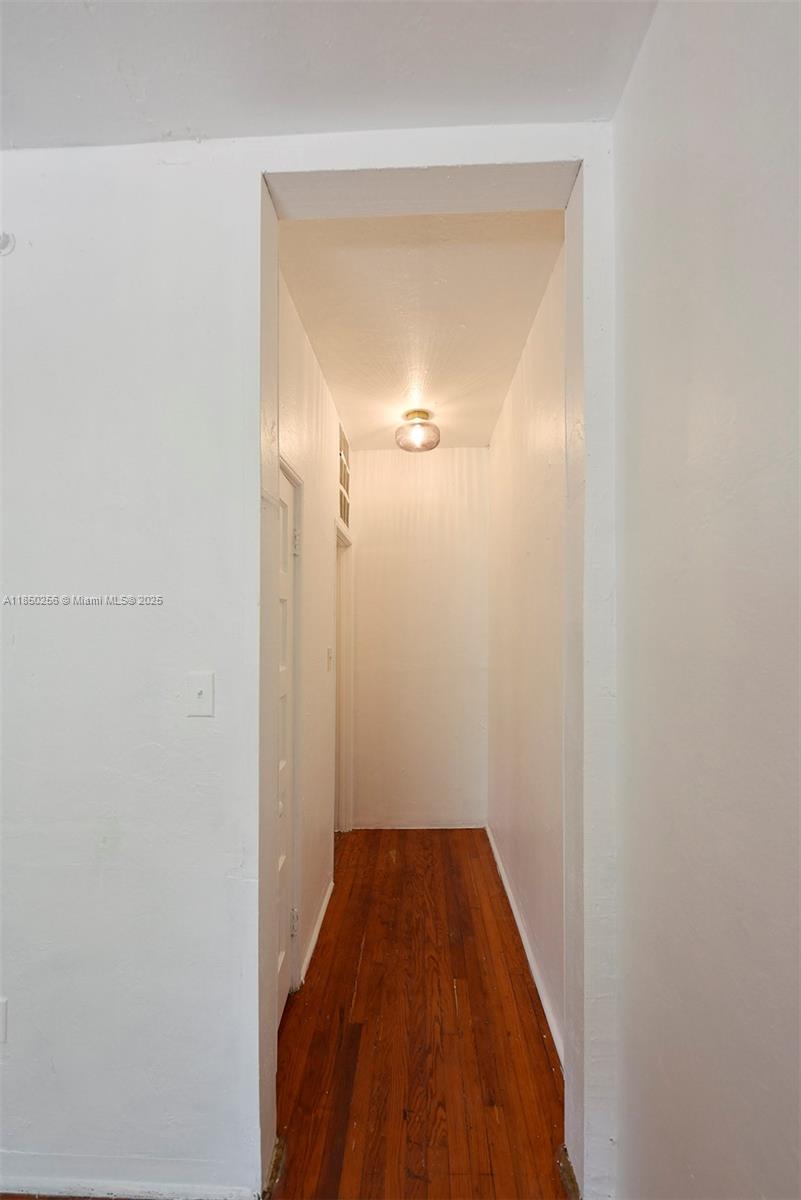 7613 Biscayne Boulevard, Unit 1 Miami, FL 33138 - Photo 14 of 16 a view of a hallway with wooden floor