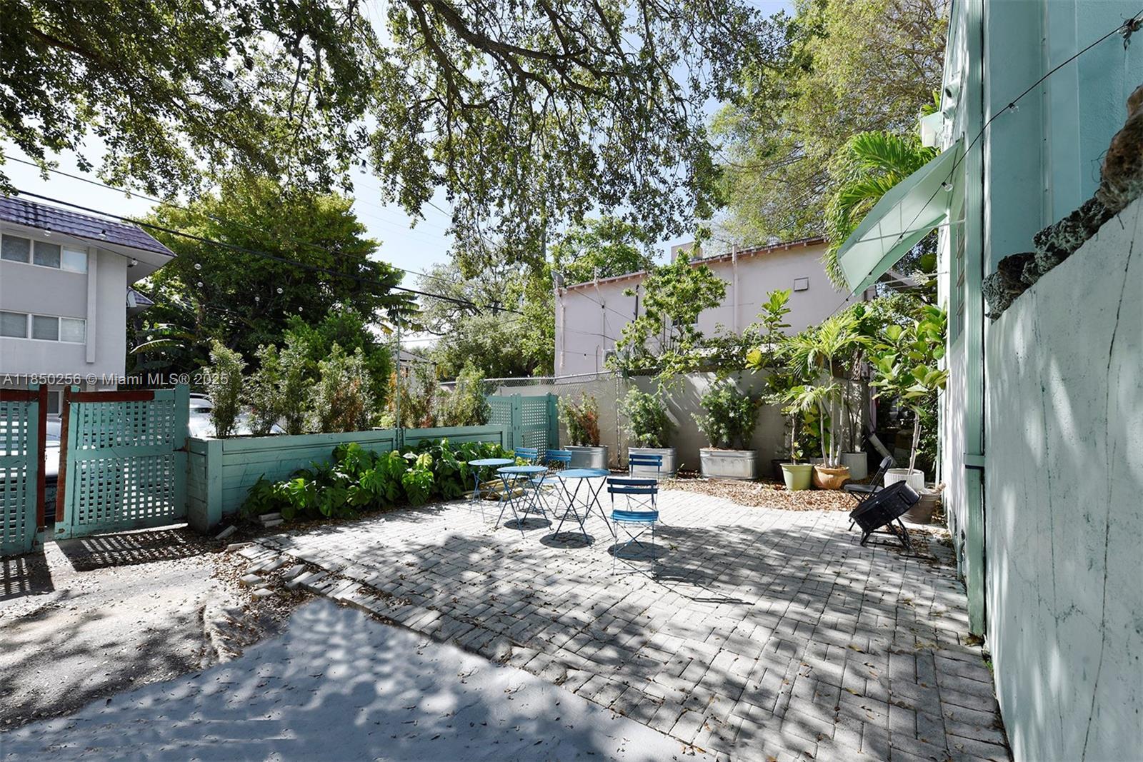7613 Biscayne Boulevard, Unit 1 Miami, FL 33138 - Photo 2 of 16 a view of a bench in a backyard