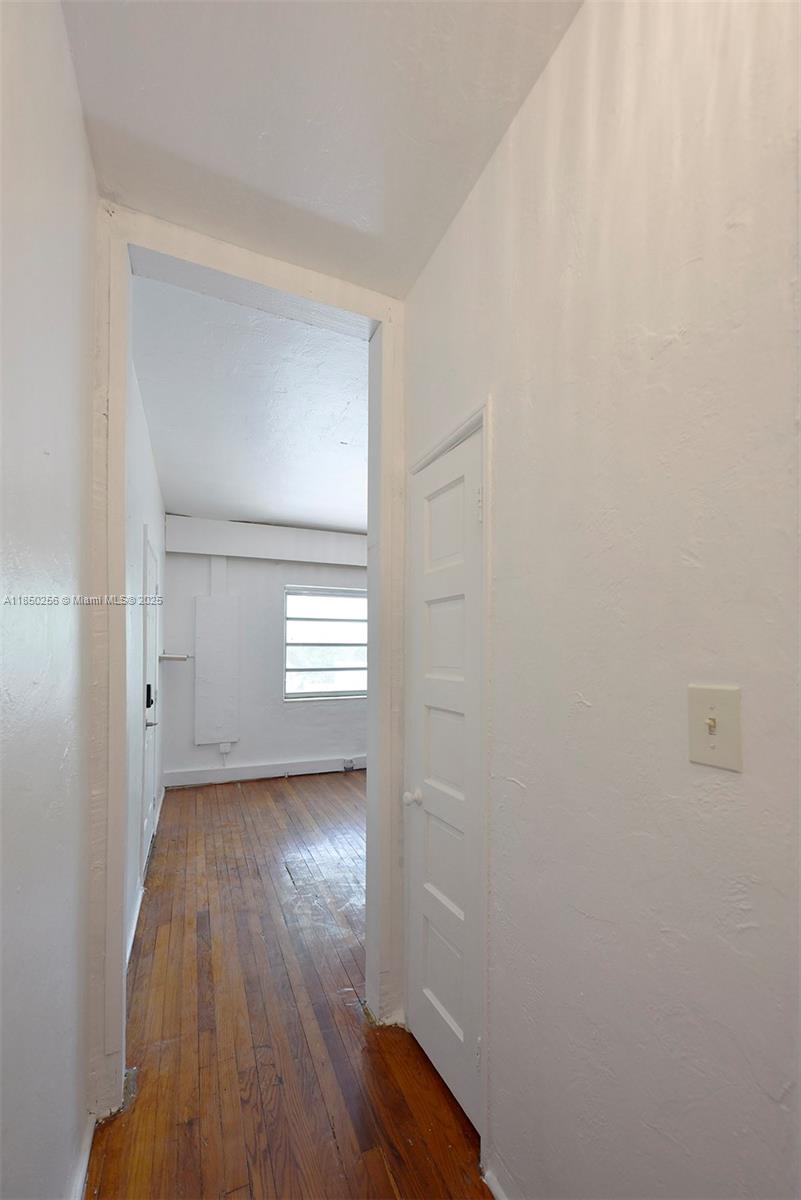 7613 Biscayne Boulevard, Unit 1 Miami, FL 33138 - Photo 8 of 16 a view of a room with wooden floor and window