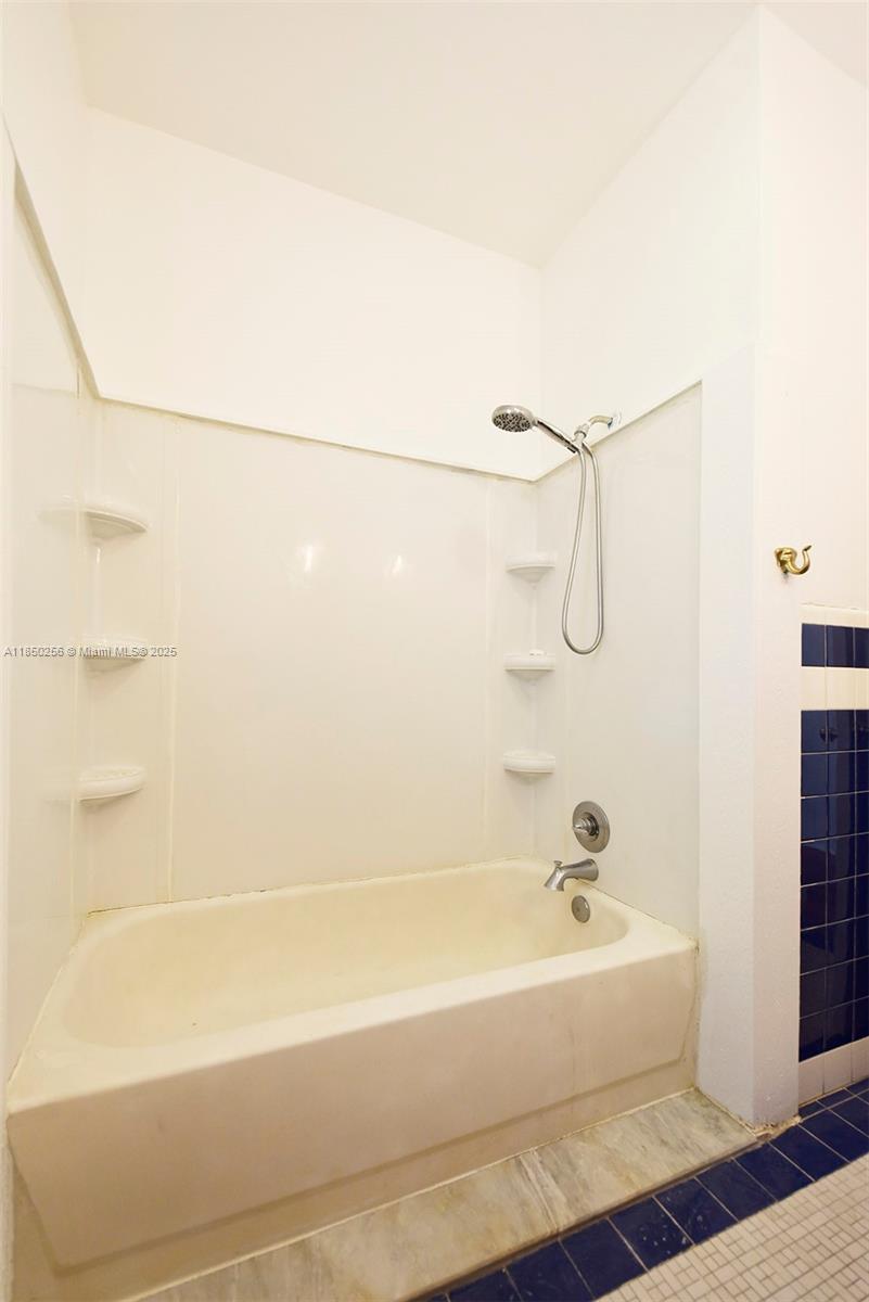 7613 Biscayne Boulevard, Unit 1 Miami, FL 33138 - Photo 10 of 16 a bathroom with a shower and a bathtub