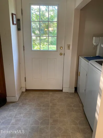 a view of a room with a door and a window