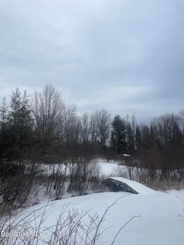 a view of a wooden deck and a yard