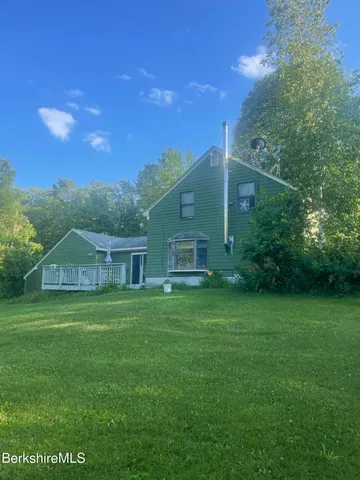 a hallway with a mirror and a fan