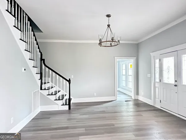 a view of entryway and hall with wooden floor