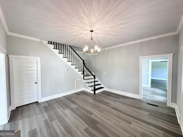 a view of entryway and hall with wooden floor