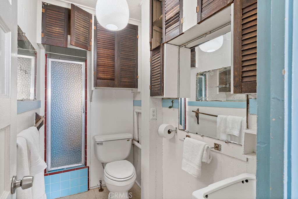 94 A Surfside Seal Beach, CA 90740 - Photo 6 of 33 a bathroom with a granite countertop window a toilet and a shower