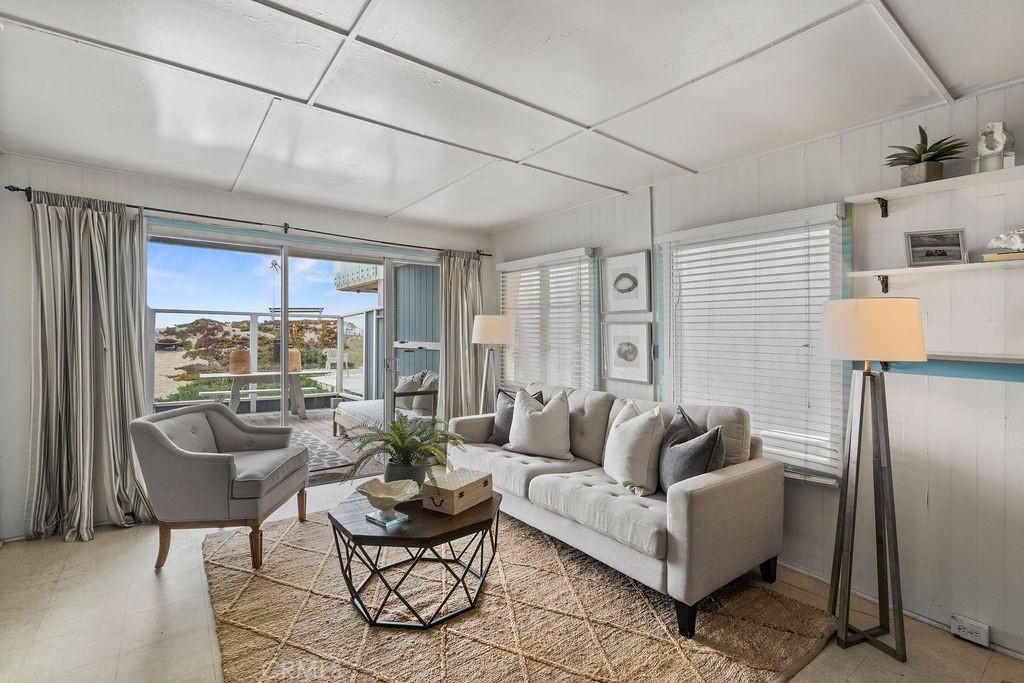 94 A Surfside Seal Beach, CA 90740 - Photo 10 of 33 a living room with furniture and a large window