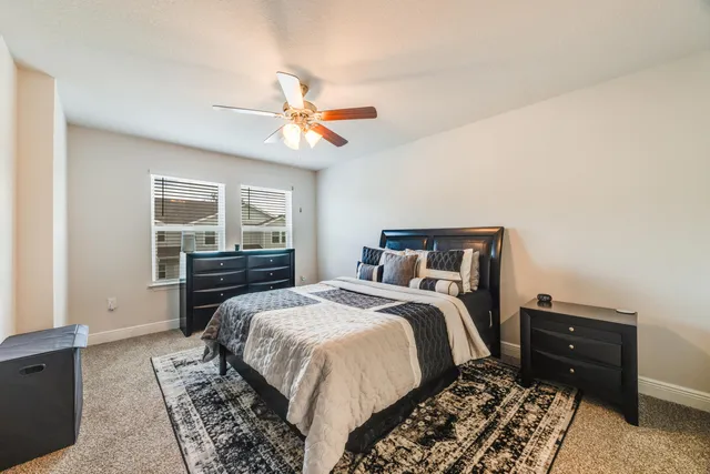 a bedroom with a bed and a chandelier