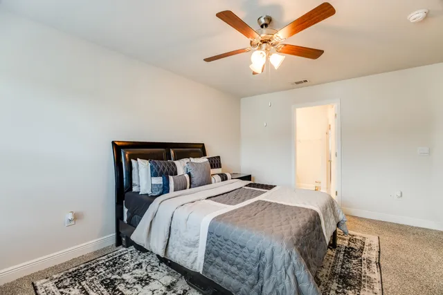 a bed sitting in a bedroom next to a window