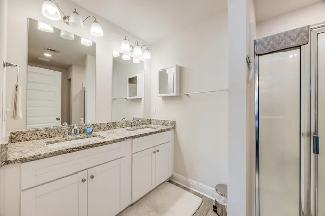 a bathroom with a double vanity sink and a mirror