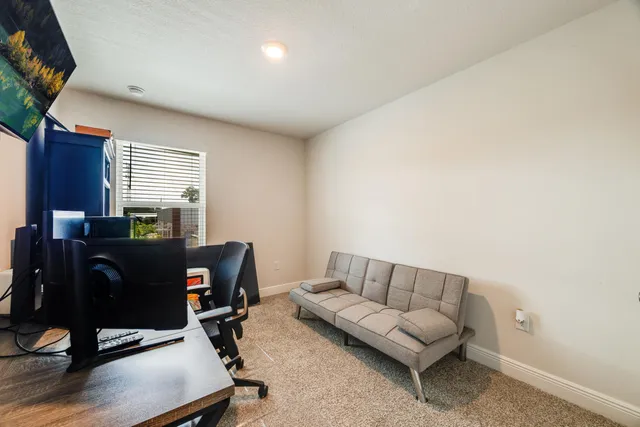 a living room with furniture rug and a window