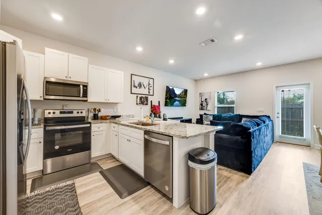 a kitchen with a sink and a stove top oven