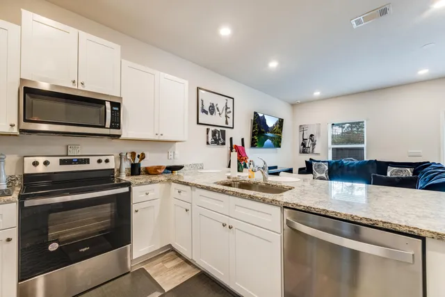 a kitchen with sink cabinets and stainless steel appliances