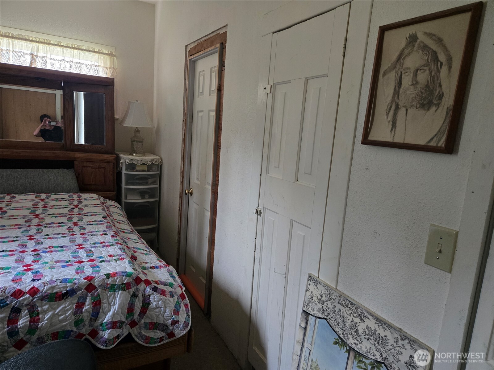 7610 Union Mills Road Southeast Lacey, WA 98503 - Photo 12 of 25 a bedroom with a bed and a mirror on dresser