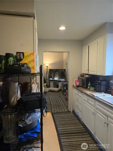 a kitchen with a refrigerator and cabinets