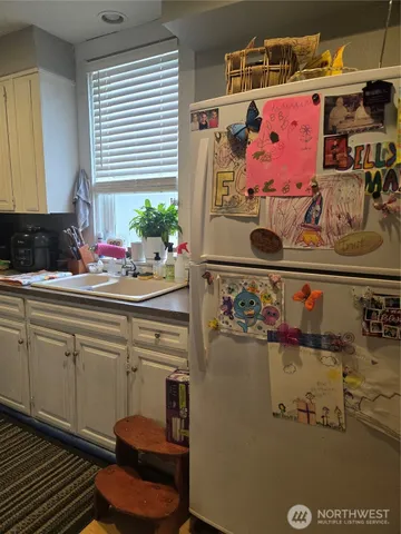 a kitchen with a stove and a refrigerator