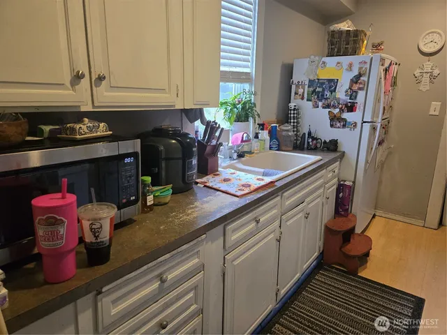 a kitchen with sink cabinets and stove