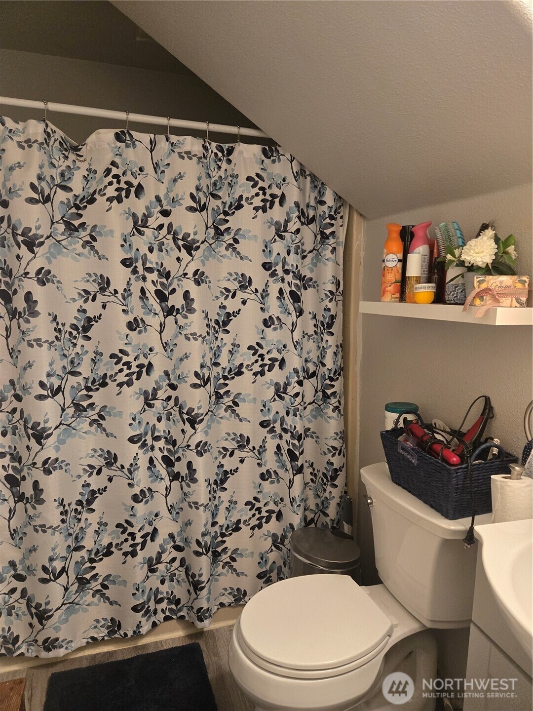 7610 Union Mills Road Southeast Lacey, WA 98503 - Photo 10 of 25 a white toilet sitting next to a sink and vanity