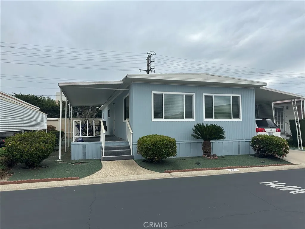 525 North Gilbert Street, Unit 151 Anaheim, CA 92801 - Photo 1 of 18 a front view of a house with a yard and garage