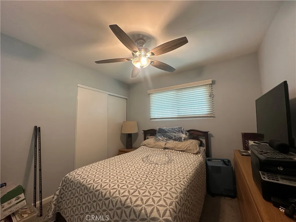 525 North Gilbert Street, Unit 151 Anaheim, CA 92801 - Photo 15 of 18 a bedroom with a bed and a flat tv screen on the dresser