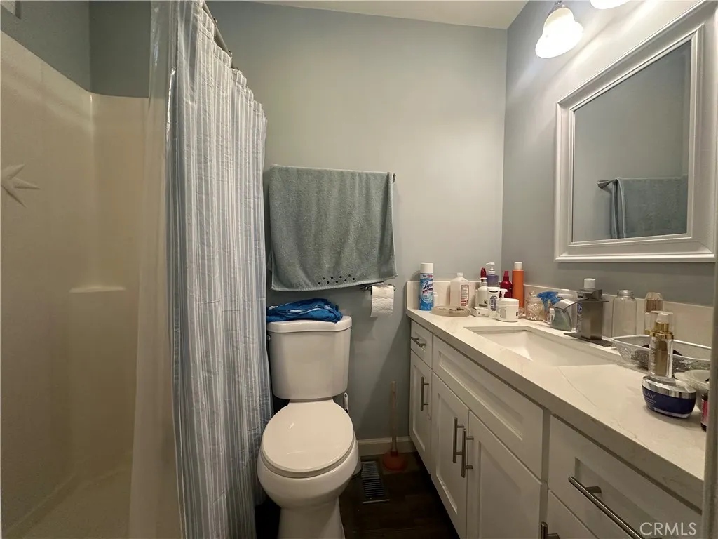 525 North Gilbert Street, Unit 151 Anaheim, CA 92801 - Photo 3 of 18 a bathroom with a toilet sink and mirror