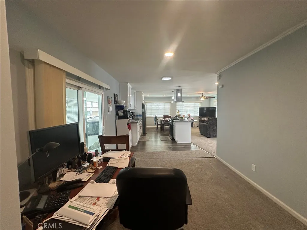 525 North Gilbert Street, Unit 151 Anaheim, CA 92801 - Photo 5 of 18 a living room with fireplace furniture and a flat screen tv