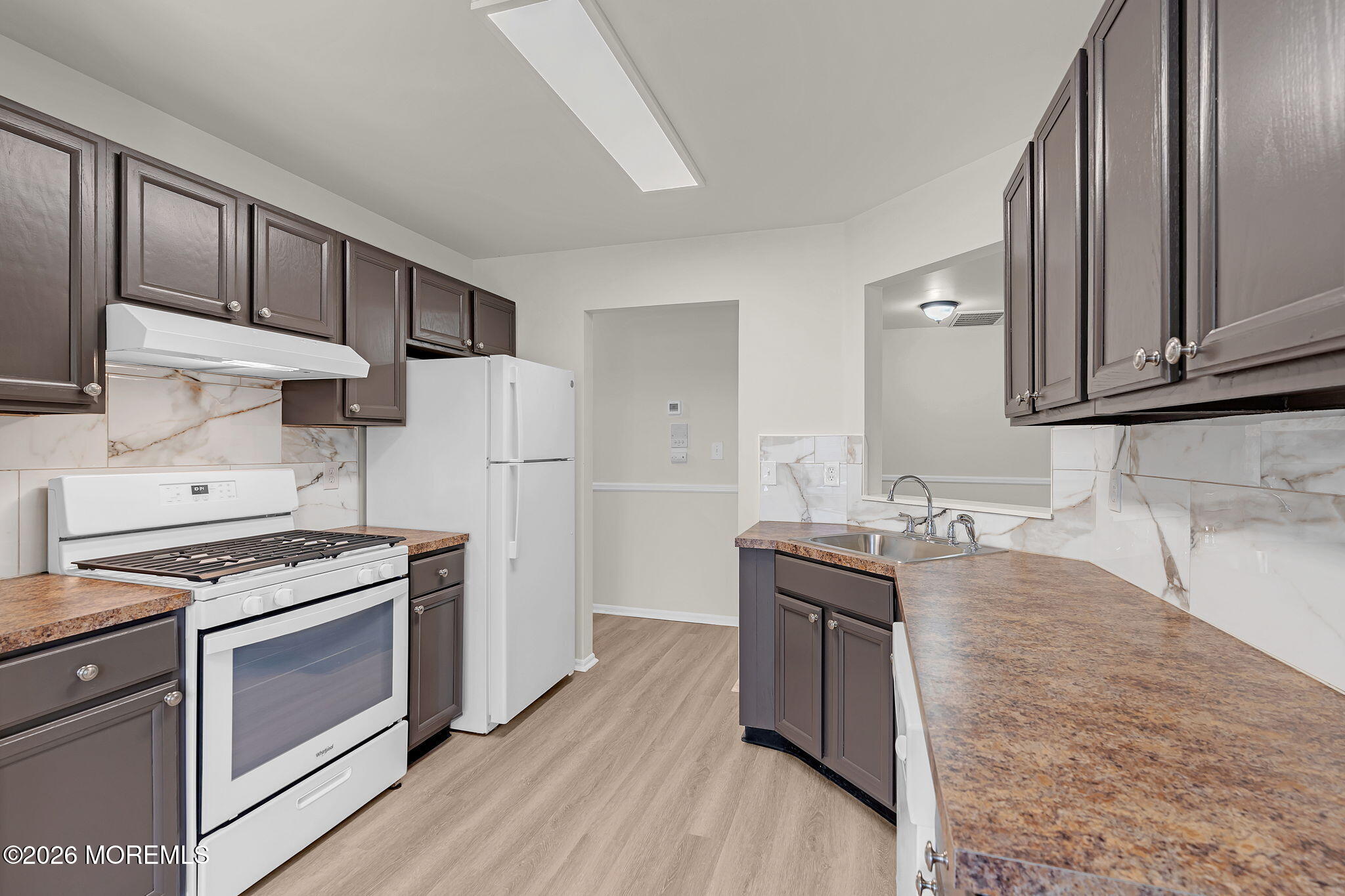 12 High Pointe Way Matawan, NJ 07747 - Photo 15 of 31 a kitchen with granite countertop wooden cabinets sink and stainless steel appliances