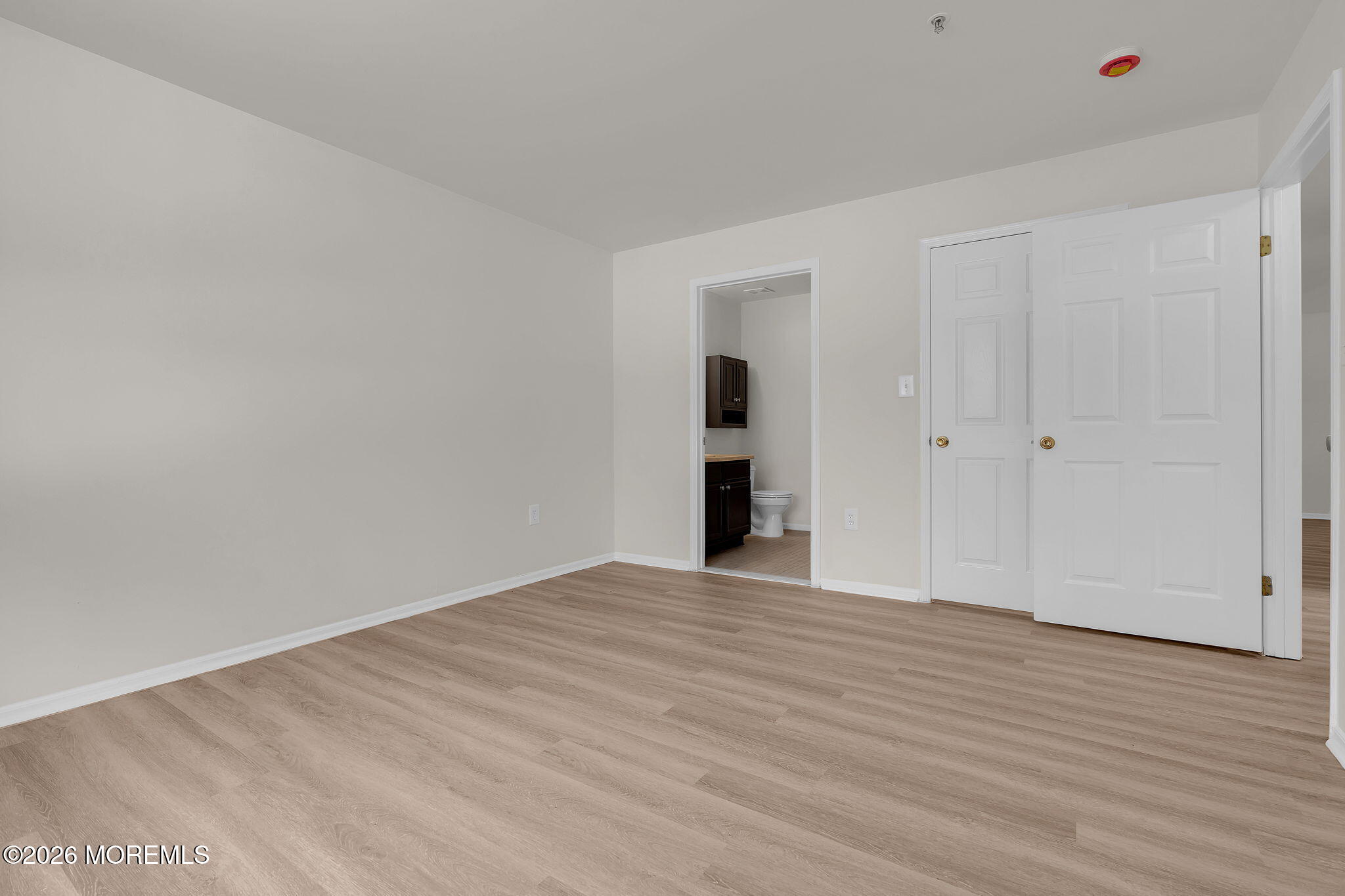 12 High Pointe Way Matawan, NJ 07747 - Photo 24 of 31 a view of an empty room with wooden floor and closet