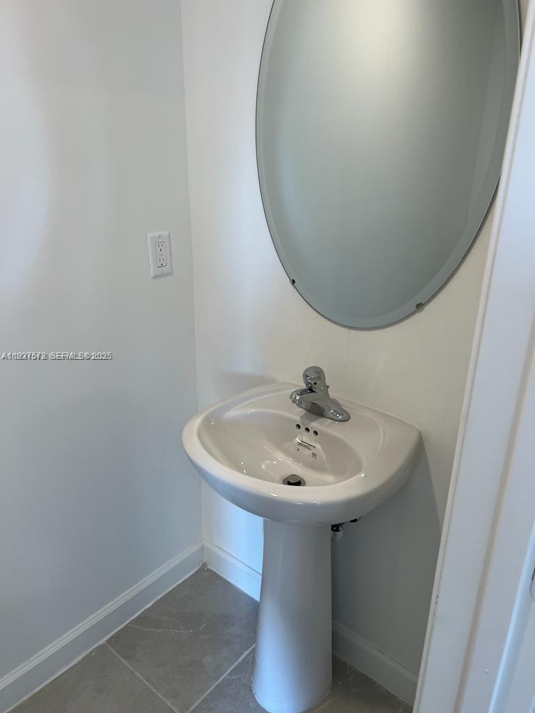 2281 Northwest 131st Circle Miami, FL 33167 - Photo 16 of 48 a bathroom with a sink and a mirror