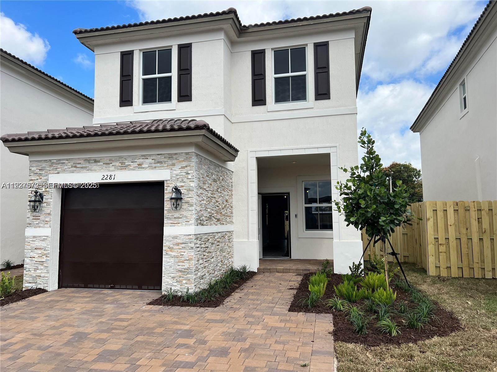 2281 Northwest 131st Circle Miami, FL 33167 - Photo 2 of 48 a front view of a house with garden