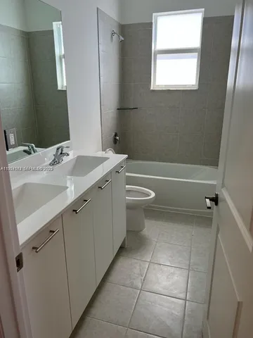 a view of a bathroom with a sink a toilet and bathtub