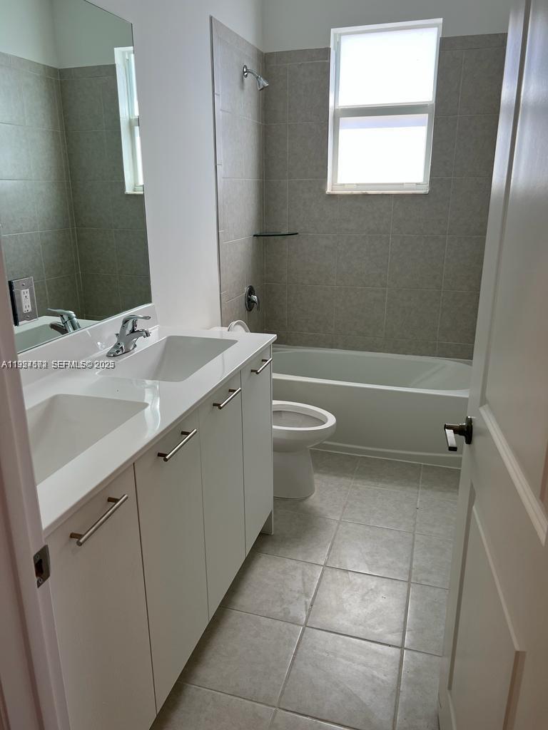 2281 Northwest 131st Circle Miami, FL 33167 - Photo 25 of 48 a view of a bathroom with a sink a toilet and bathtub