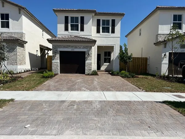 a front view of a house with yard
