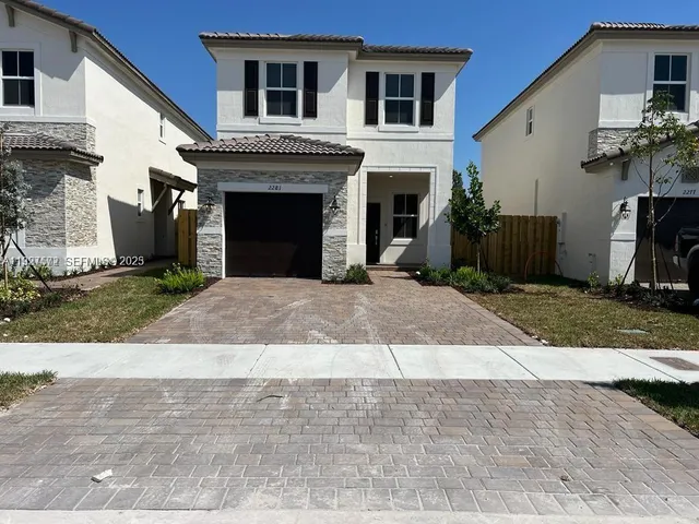 a front view of a house with yard