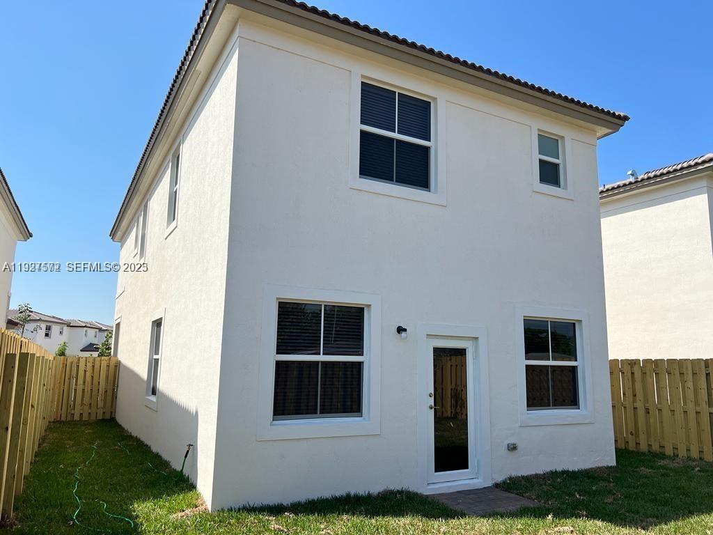 2281 Northwest 131st Circle Miami, FL 33167 - Photo 34 of 48 a view of white house with a yard