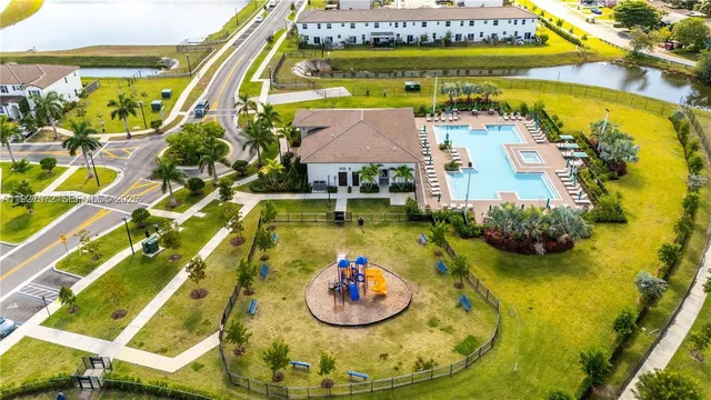a swimming pool with a table and chairs