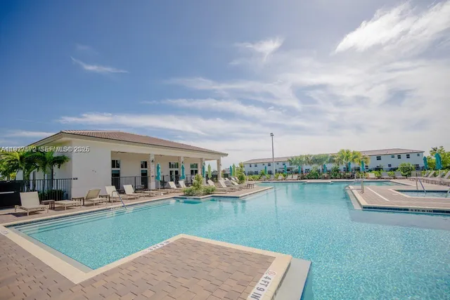 a view of a house with pool and lake view